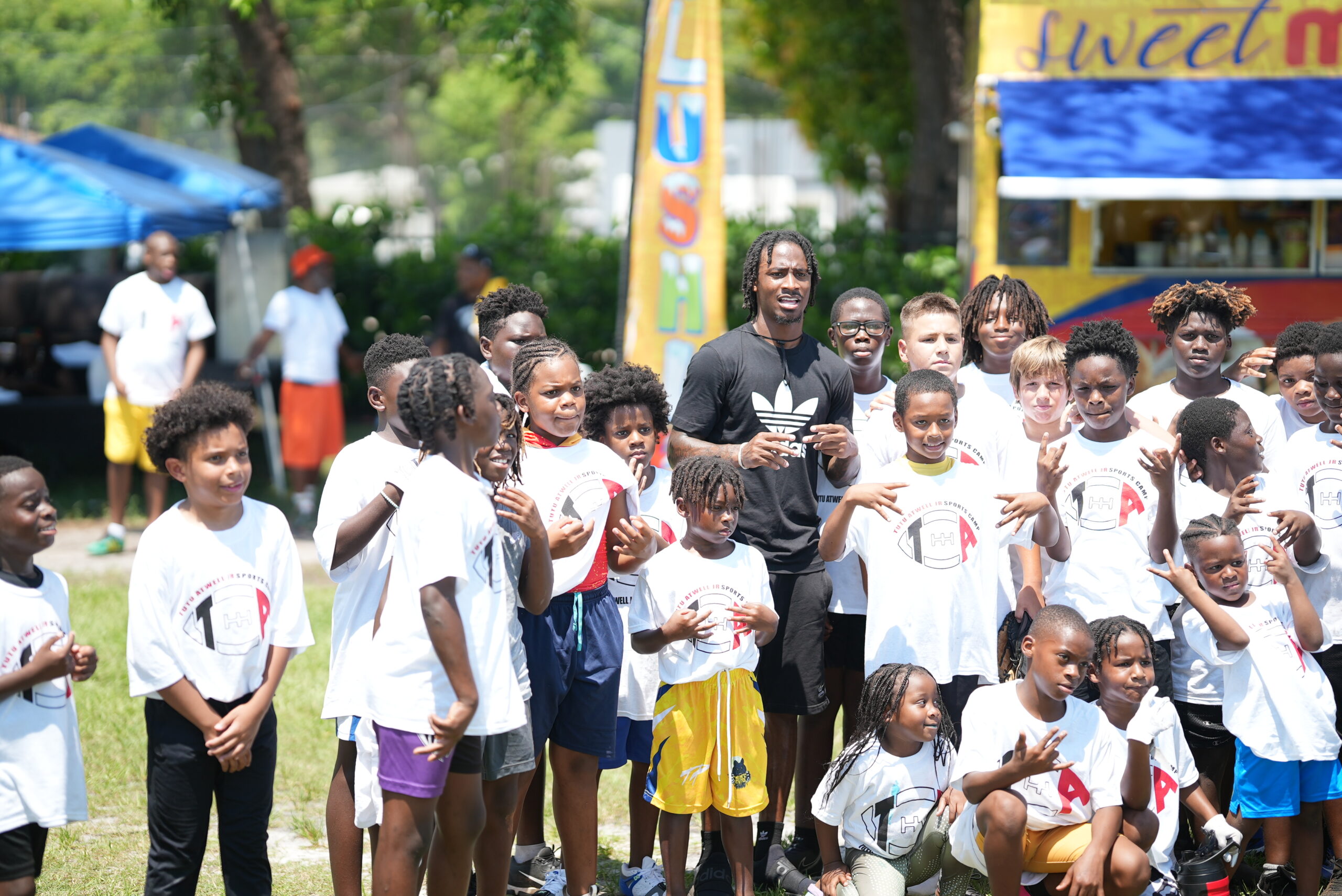 Tutu Atwell standing with youth at a foundation event