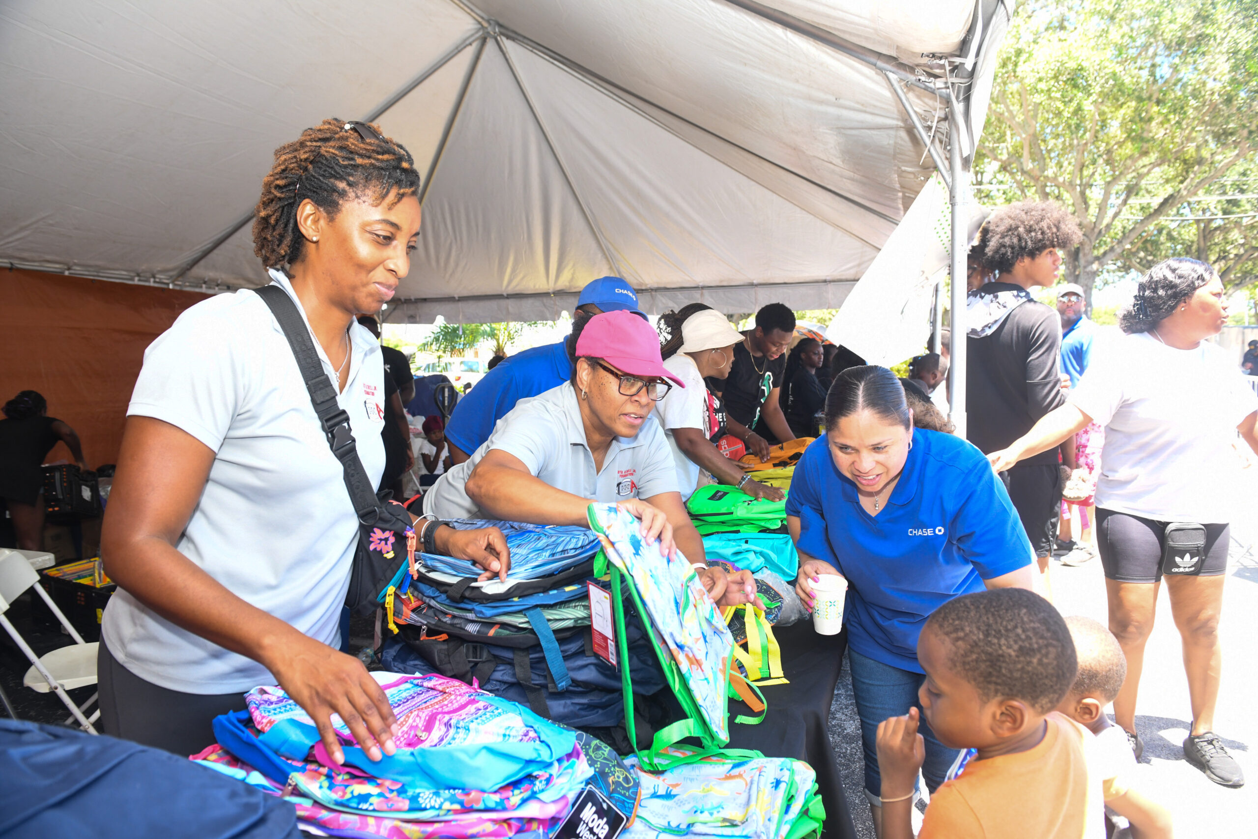 Foundation team distributing backpacks at a back-to-school giveaway