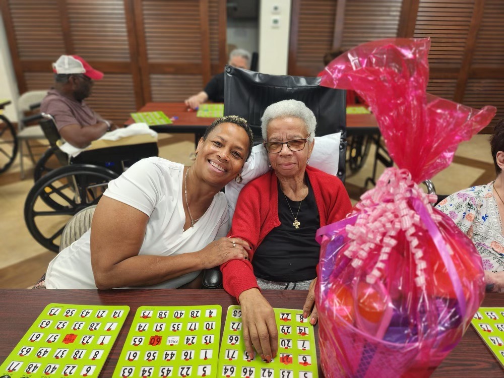 Volunteer smiling with a senior during a care visit