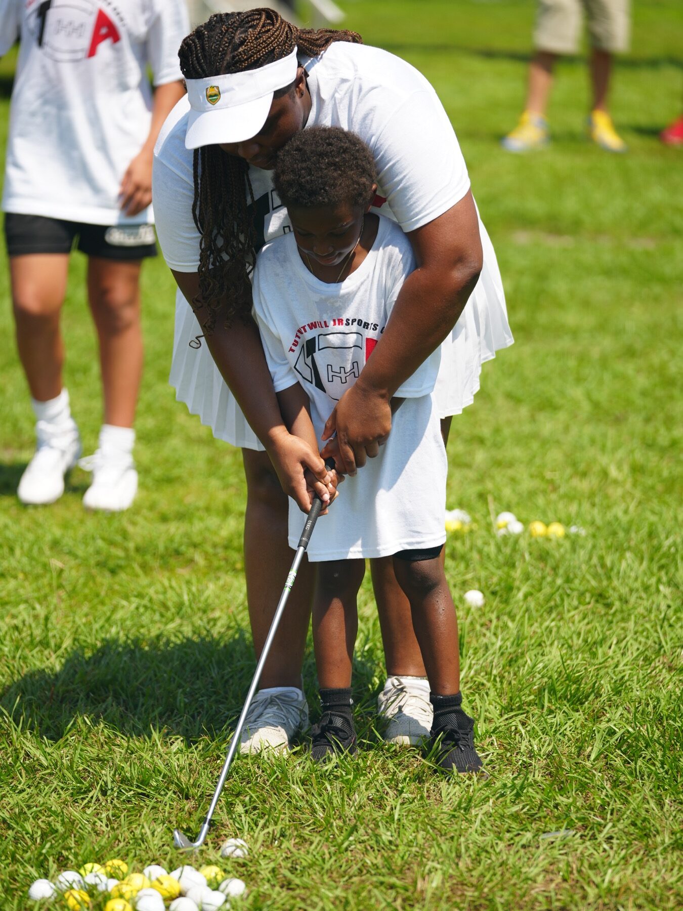 Youth participant learning golf fundamentals during a foundation sports activity