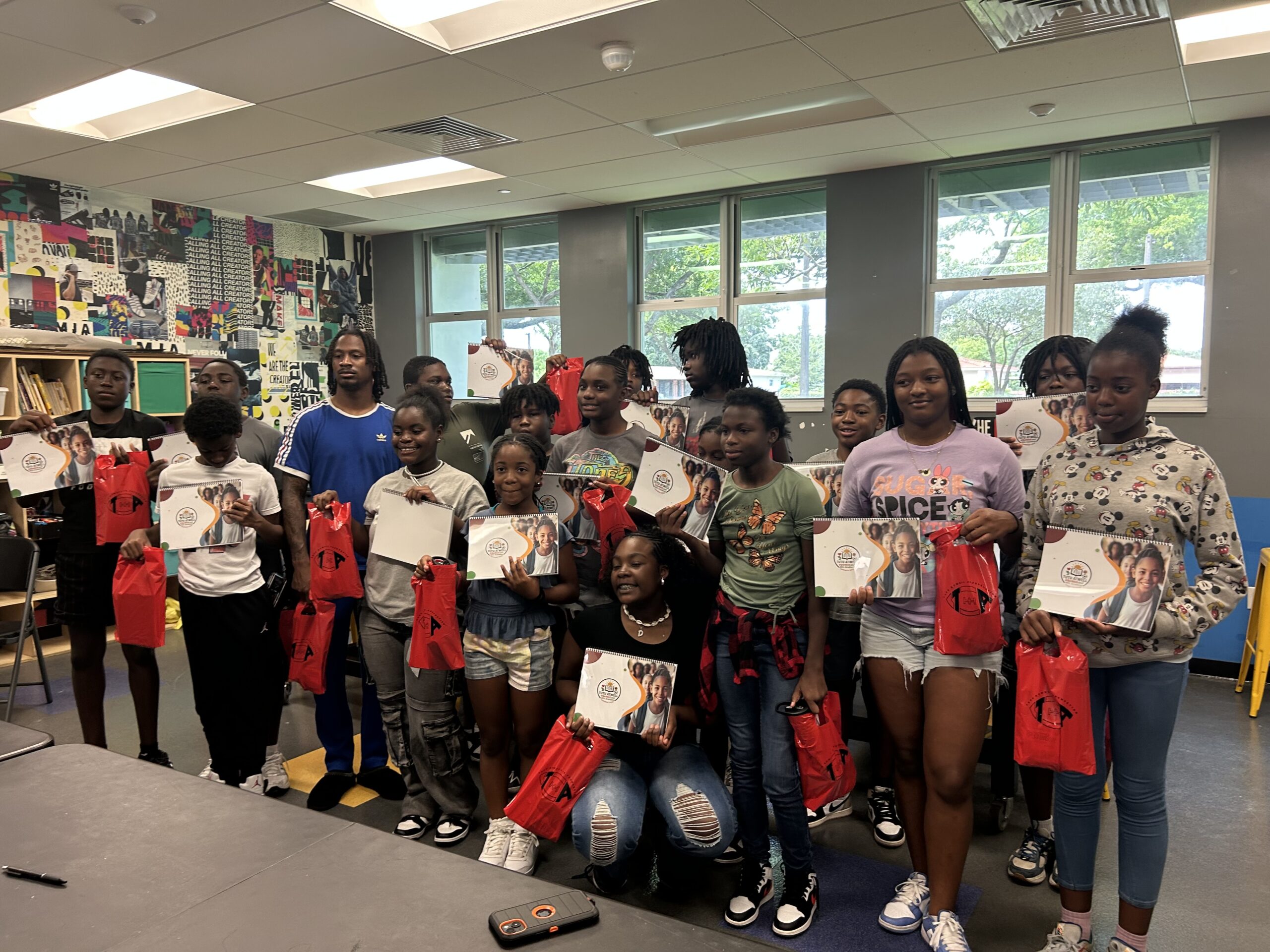 Youth academy workshop with participants holding program materials