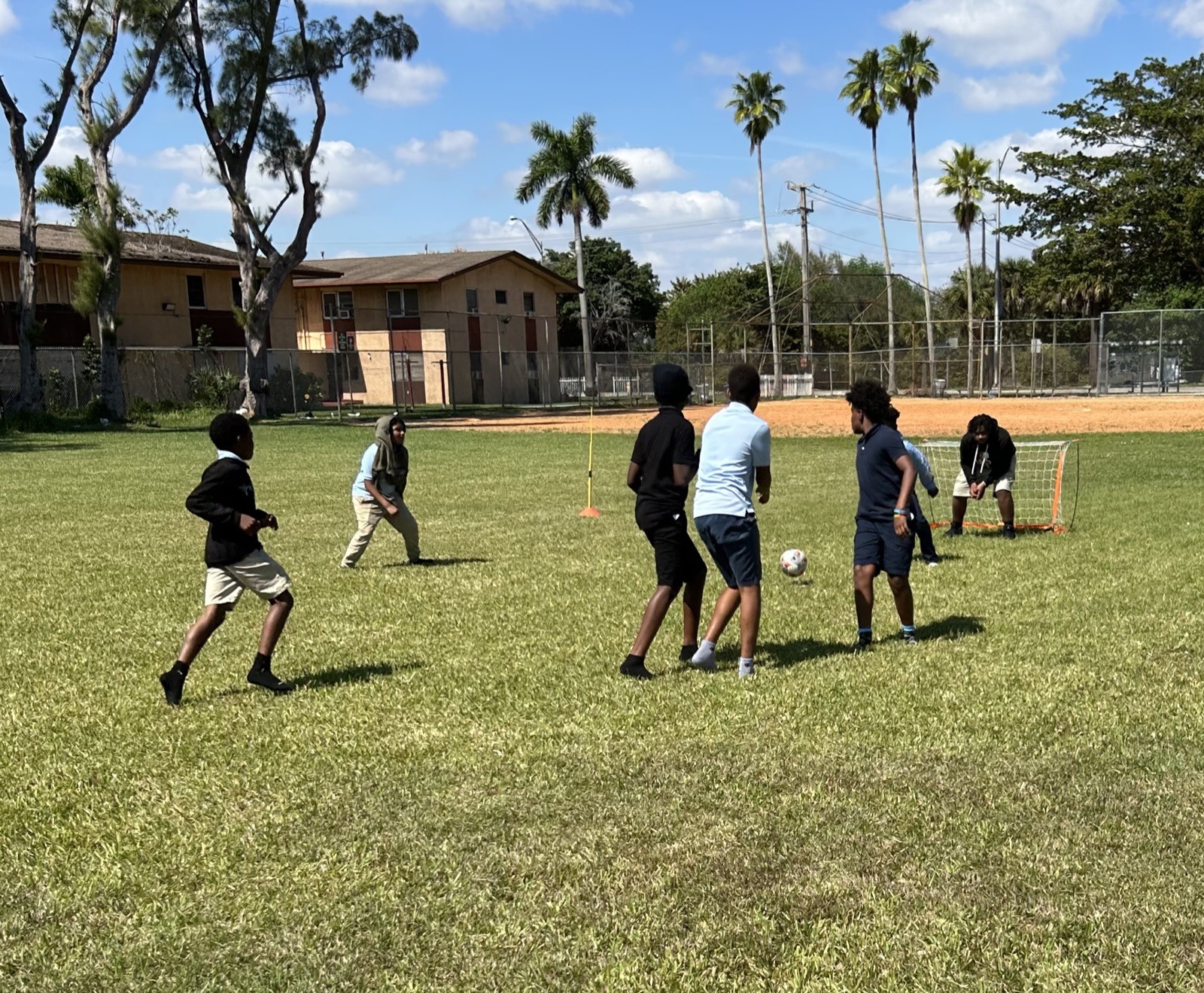 Youth playing soccer during a foundation field day activation