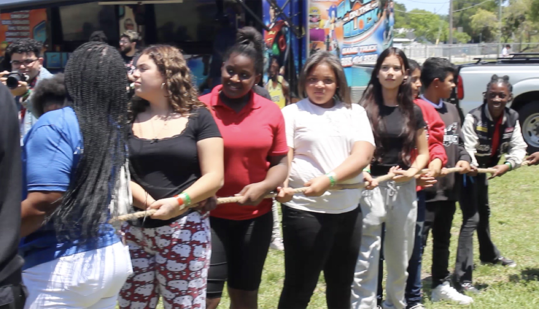 Students participating in field day tug of war